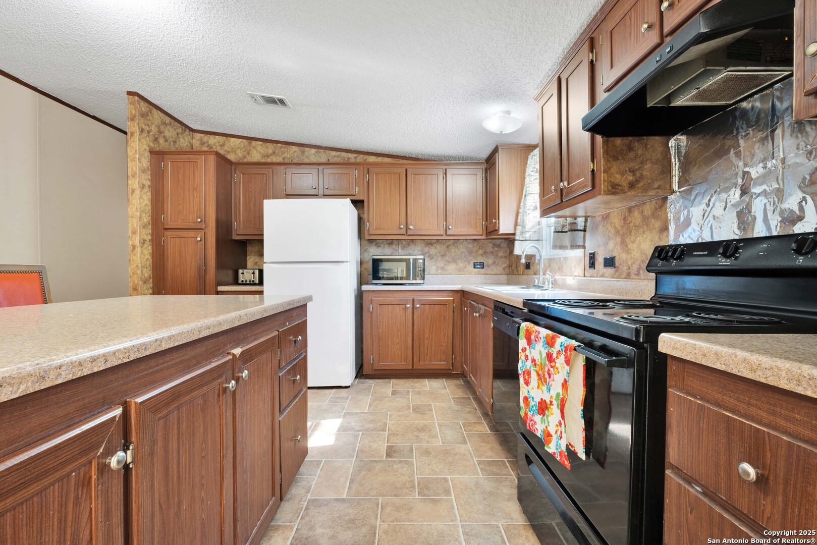 7176 Burshard Road San Antonio, TX 78263 - Photo 8 of 20 a kitchen with stainless steel appliances granite countertop a stove a sink dishwasher and a refrigerator