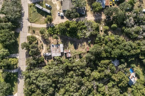 an aerial view of a house with a yard and garden