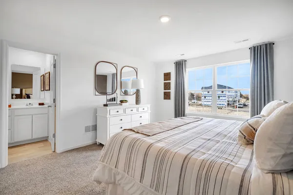 a bedroom with a bed and a view of bathroom