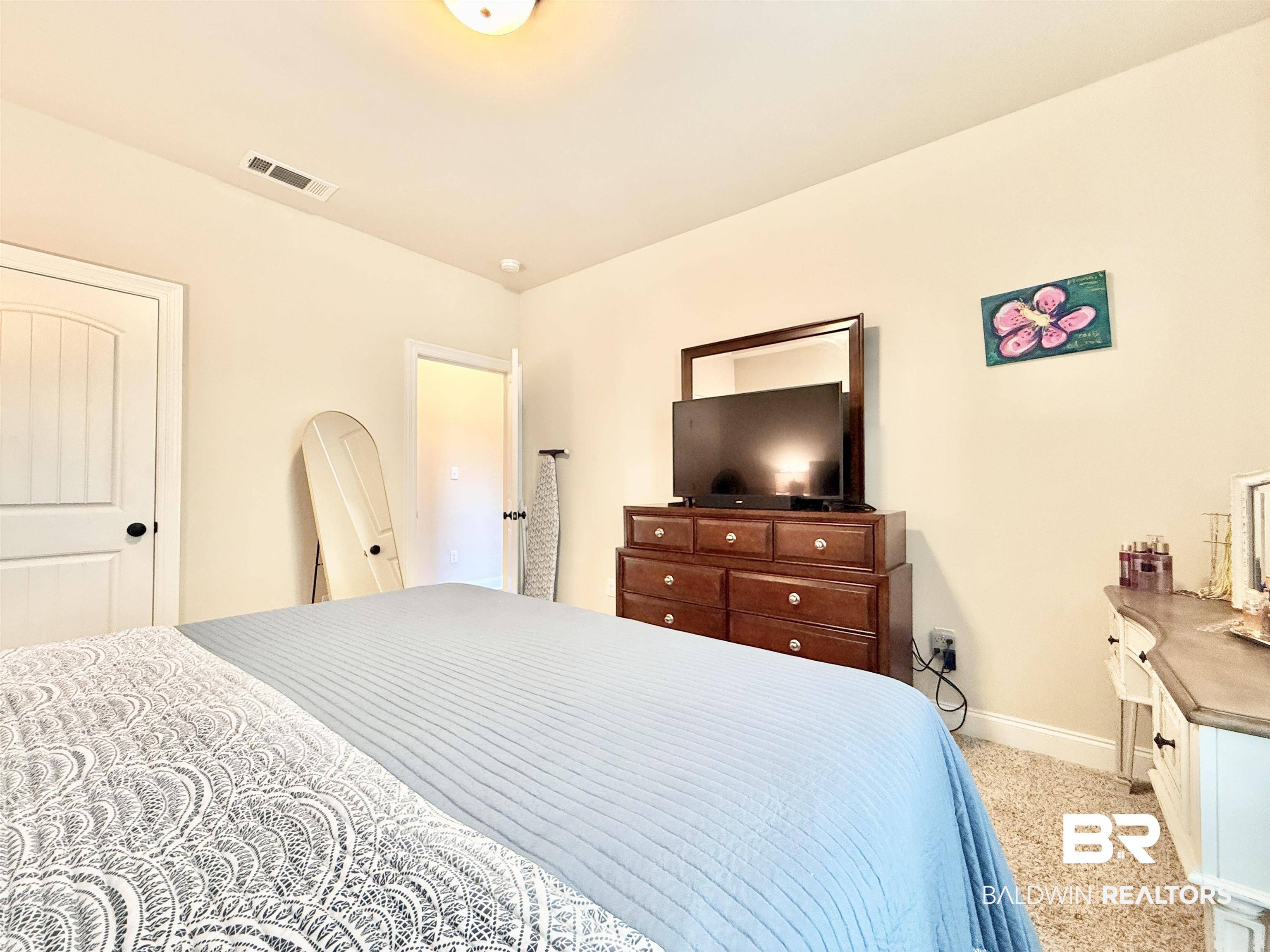 7011 Rocky Rd Loop Gulf Shores, AL 36542 - Photo 43 of 66 Bedroom featuring baseboards and light carpet
