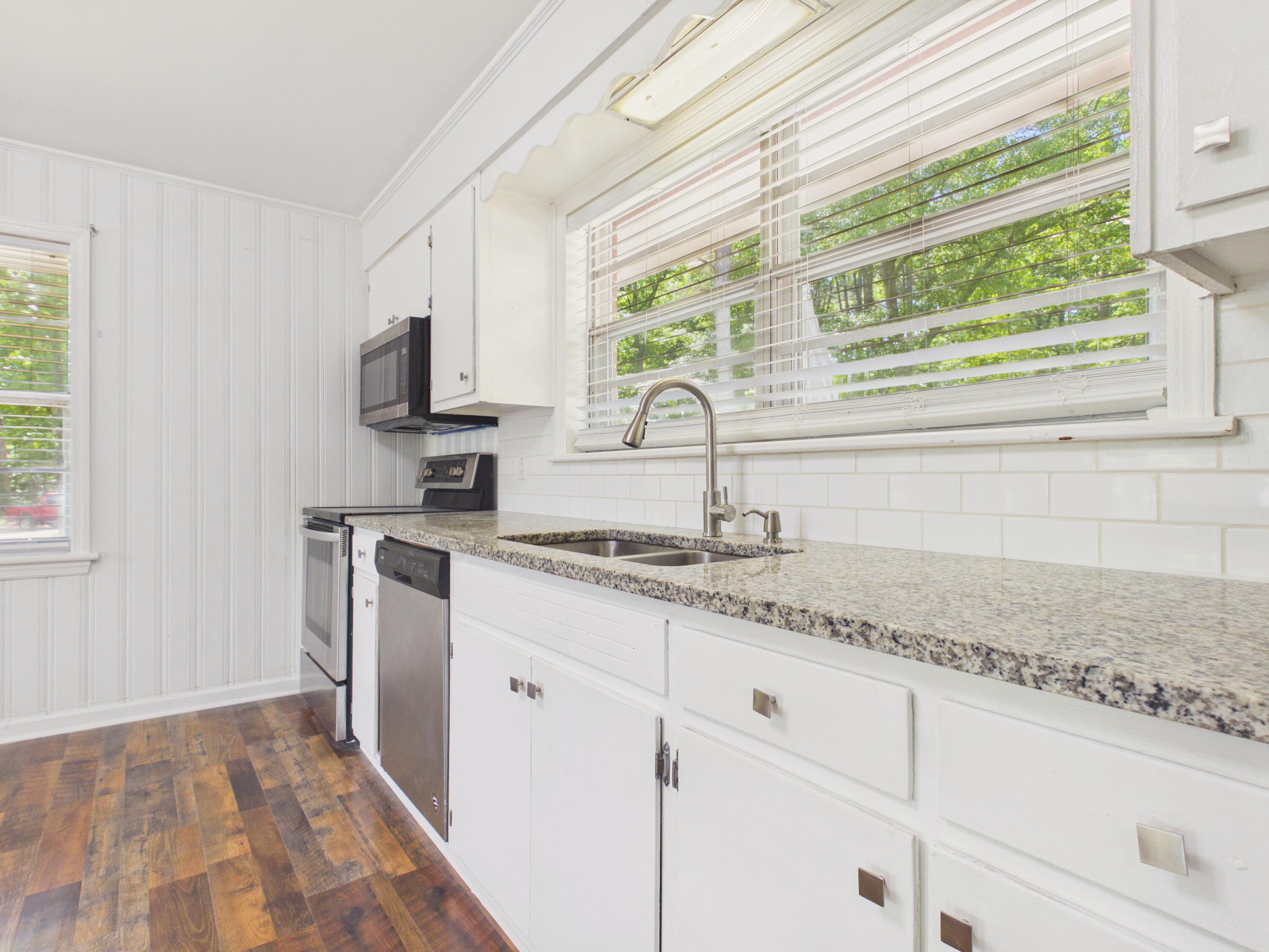 800 Old Whiskey Road South New Ellenton, SC 29809 - Photo 9 of 31 a kitchen with granite countertop a sink and a window