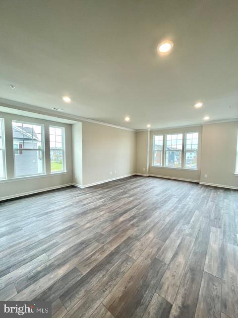7103 Delegate Place Frederick, MD 21703 - Photo 12 of 42 an empty room with wooden floor and windows
