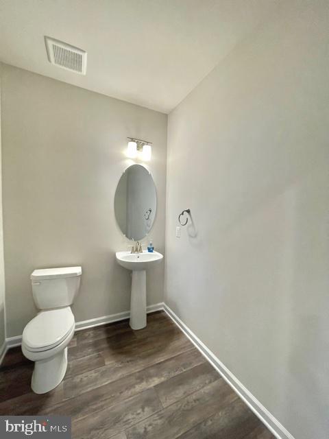 7103 Delegate Place Frederick, MD 21703 - Photo 14 of 42 a bathroom with a toilet a sink and mirror