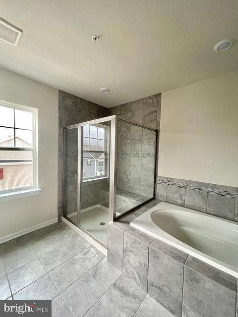 7103 Delegate Place Frederick, MD 21703 - Photo 29 of 42 a spacious bathroom with a granite countertop sink a mirror and a bathtub