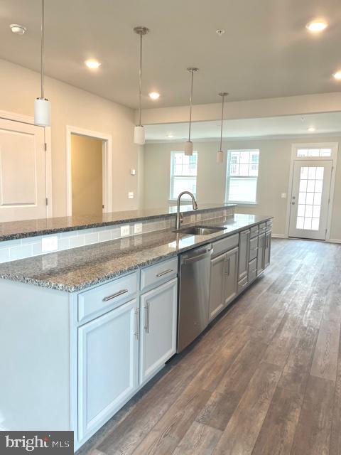 7103 Delegate Place Frederick, MD 21703 - Photo 10 of 42 a kitchen with stainless steel appliances granite countertop a sink a stove and a wooden floors