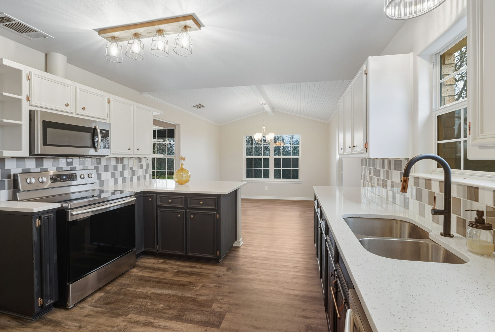 20808 Sandy Brown Lane Webberville, TX 78621 - Photo 11 of 40 a kitchen with a sink stove and microwave