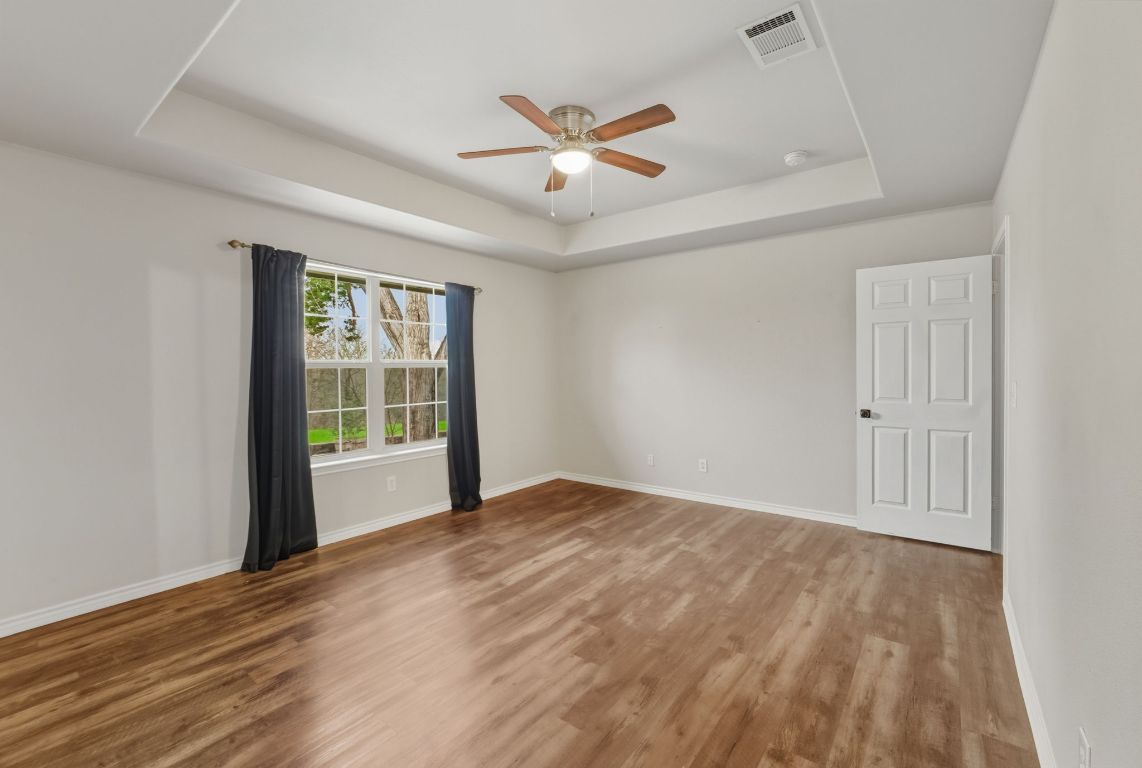 20808 Sandy Brown Lane Webberville, TX 78621 - Photo 12 of 40 wooden floor in an empty room with a window
