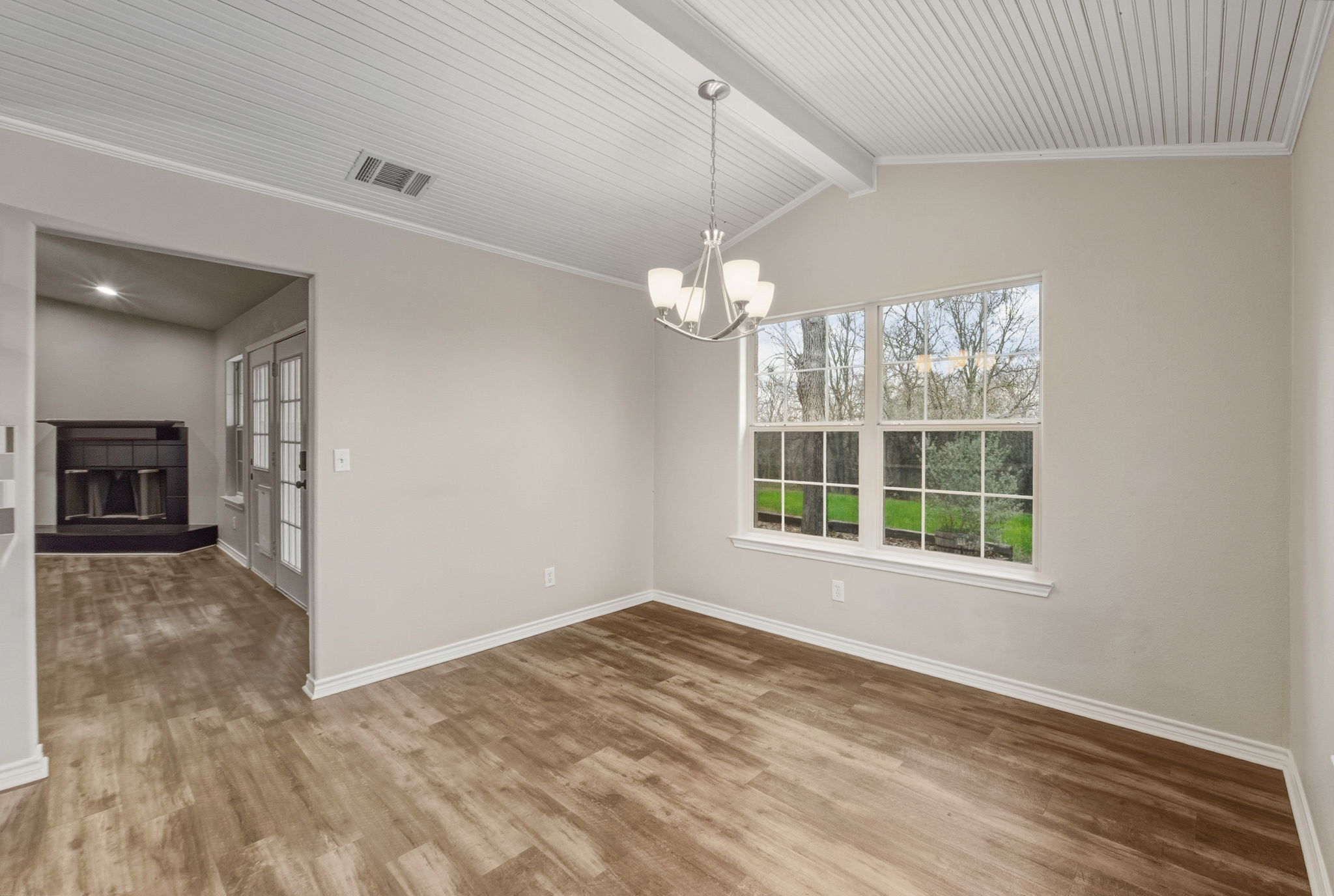 20808 Sandy Brown Lane Webberville, TX 78621 - Photo 12 of 40 en empty room with windows and chandelier