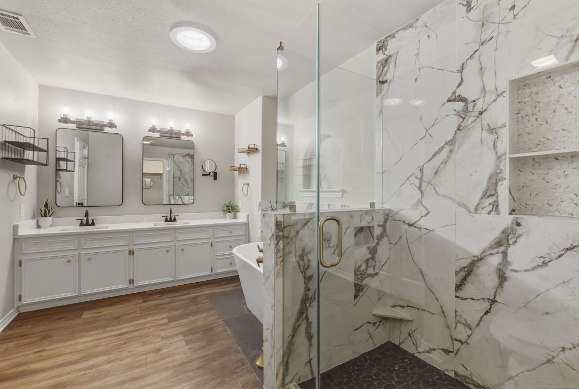 20808 Sandy Brown Lane Webberville, TX 78621 - Photo 14 of 40 a large bathroom with double vanity and a shower