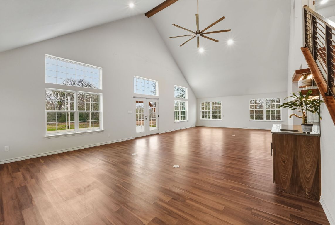 20808 Sandy Brown Lane Webberville, TX 78621 - Photo 16 of 40 a view of an empty room with wooden floor and a window