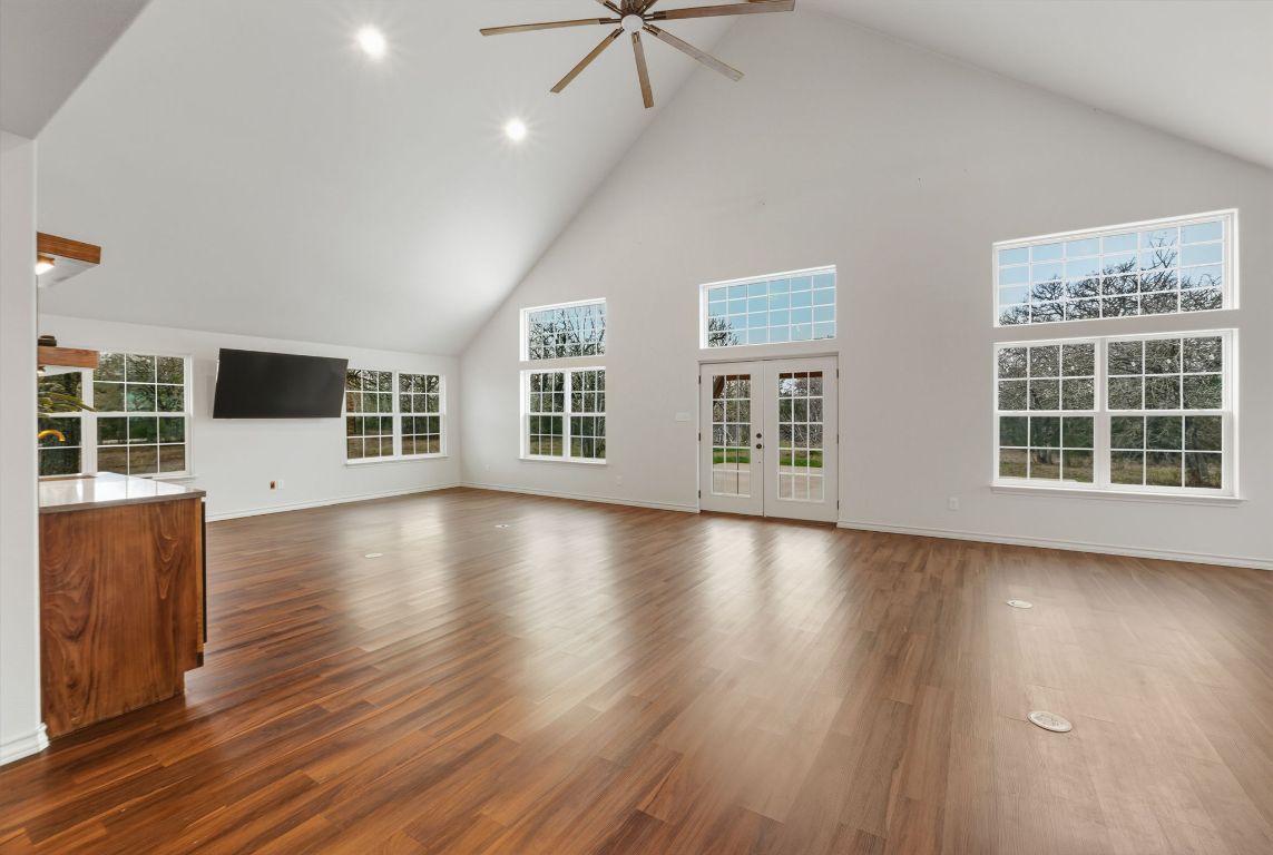 20808 Sandy Brown Lane Webberville, TX 78621 - Photo 19 of 40 a view of a livingroom with wooden floor and window