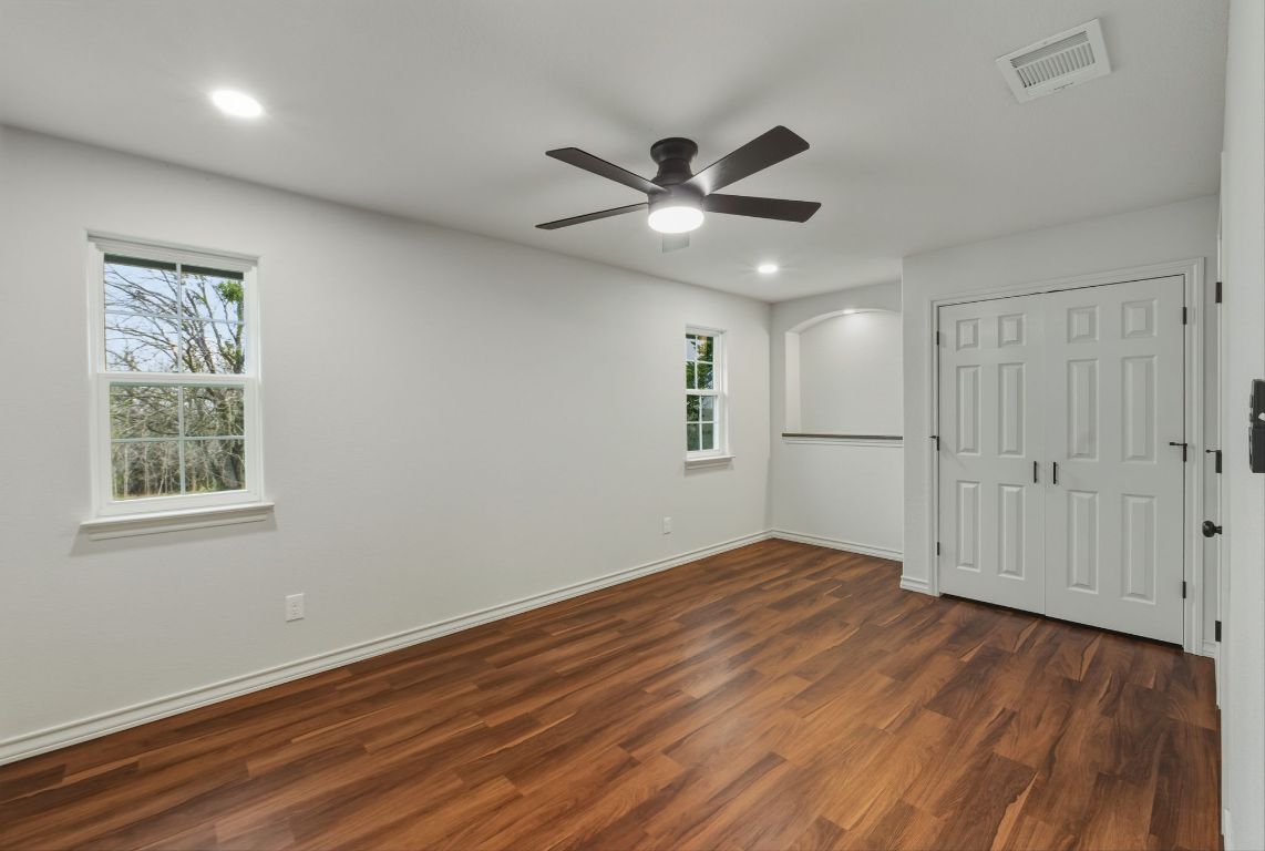 20808 Sandy Brown Lane Webberville, TX 78621 - Photo 20 of 40 a view of empty room with wooden floor and fan