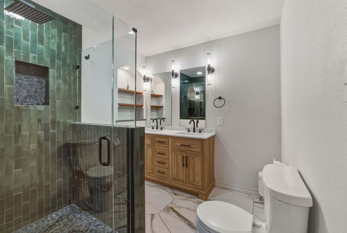 20808 Sandy Brown Lane Webberville, TX 78621 - Photo 22 of 40 a bathroom with a toilet a sink and mirror