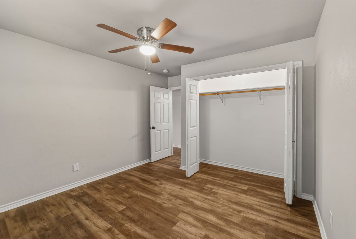 20808 Sandy Brown Lane Webberville, TX 78621 - Photo 25 of 40 a view of a livingroom with a ceiling fan & hardwood floor