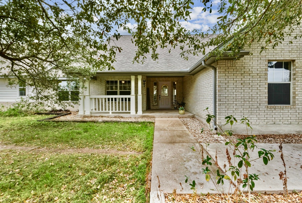 20808 Sandy Brown Lane Webberville, TX 78621 - Photo 3 of 40 a front view of a house with garden