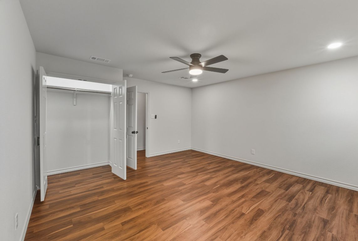 20808 Sandy Brown Lane Webberville, TX 78621 - Photo 32 of 40 a view of an empty room with wooden floor
