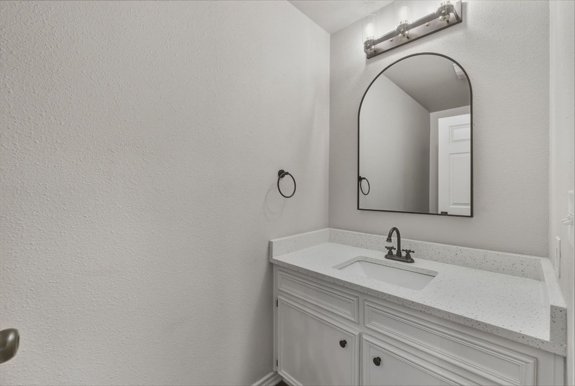 20808 Sandy Brown Lane Webberville, TX 78621 - Photo 33 of 40 a bathroom with a sink vanity and mirror