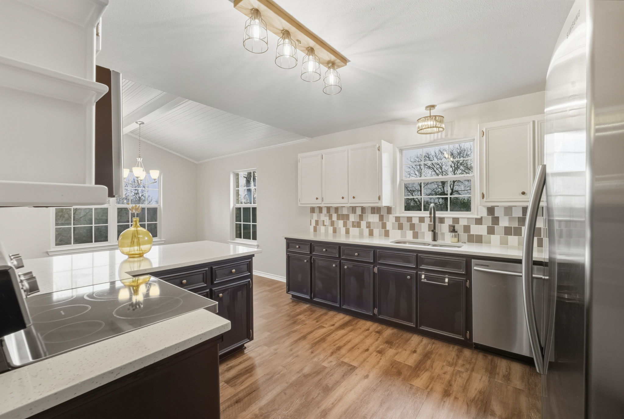 20808 Sandy Brown Lane Webberville, TX 78621 - Photo 10 of 40 a kitchen with stainless steel appliances granite countertop a sink dishwasher and a refrigerator with wooden floor