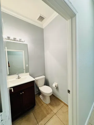 a bathroom with a double vanity sink toilet and mirror