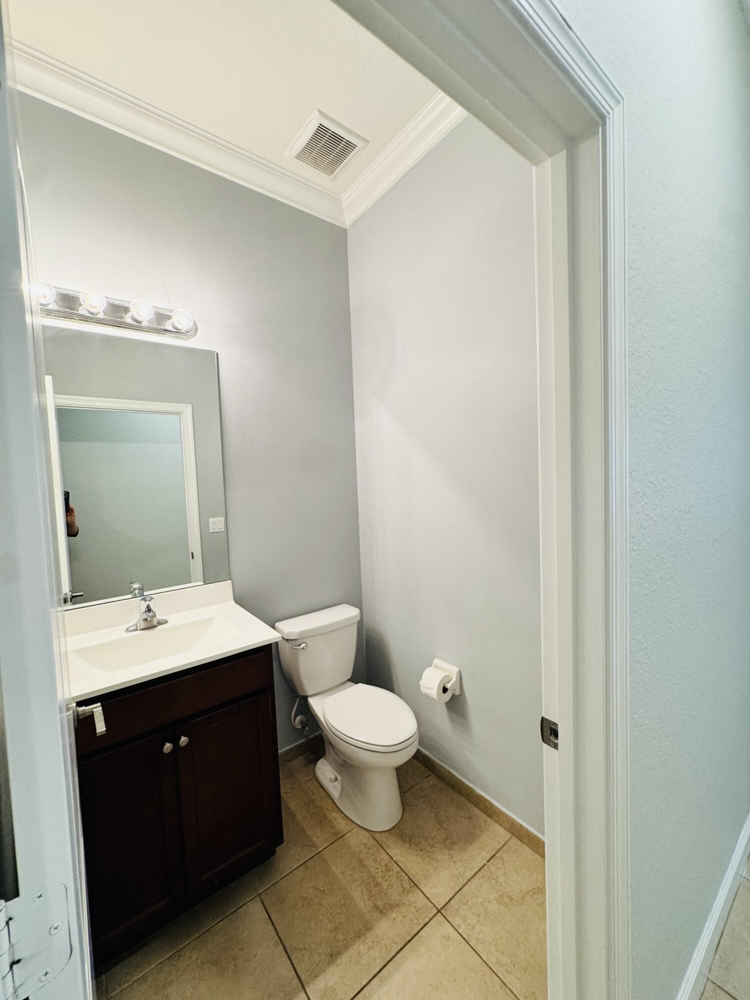 1807 Berkshire Circle Southwest Vero Beach, FL 32968 - Photo 11 of 22 a bathroom with a double vanity sink toilet and mirror