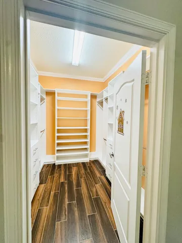 a view of a bedroom with wooden floor and walls