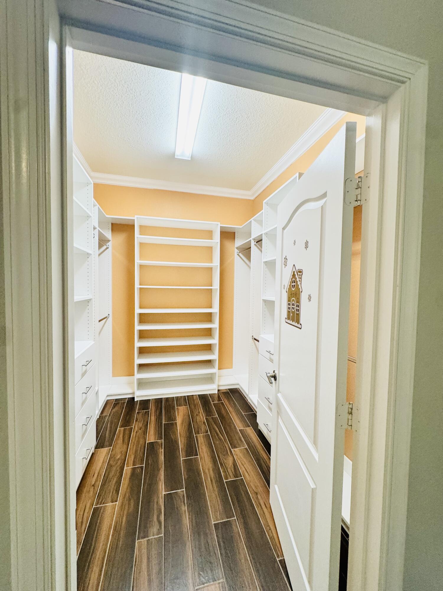 1807 Berkshire Circle Southwest Vero Beach, FL 32968 - Photo 13 of 22 a view of a bedroom with wooden floor and walls