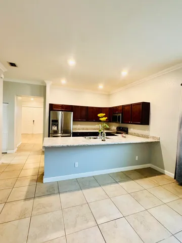 a view of hallway with a couch and a fireplace