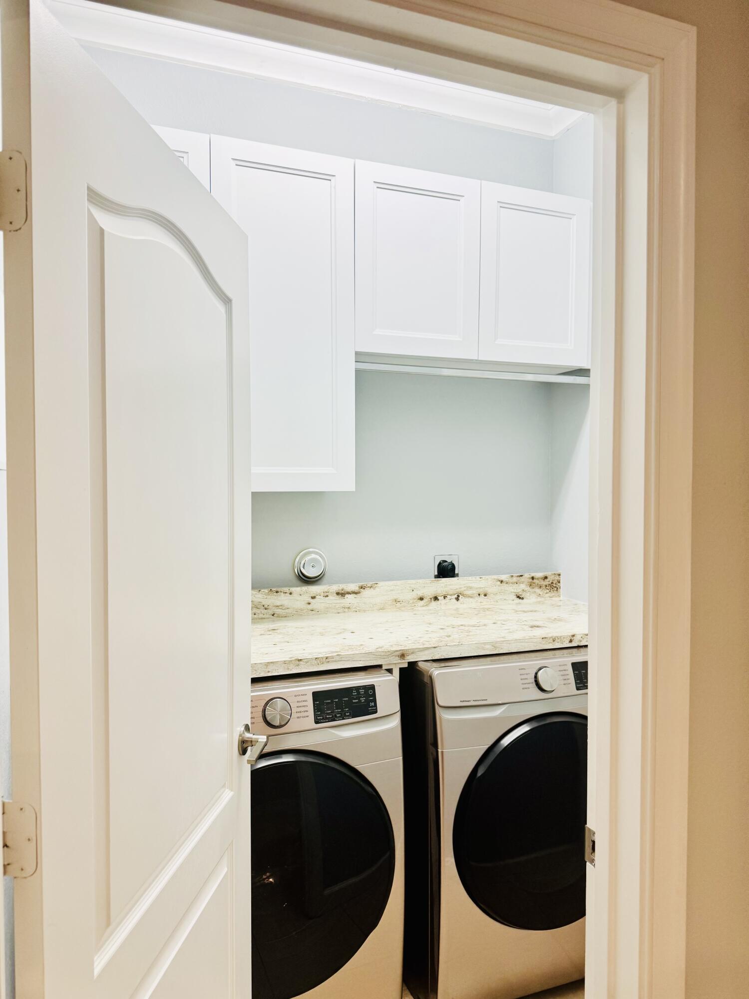 1807 Berkshire Circle Southwest Vero Beach, FL 32968 - Photo 19 of 22 a utility room with dryer and washer
