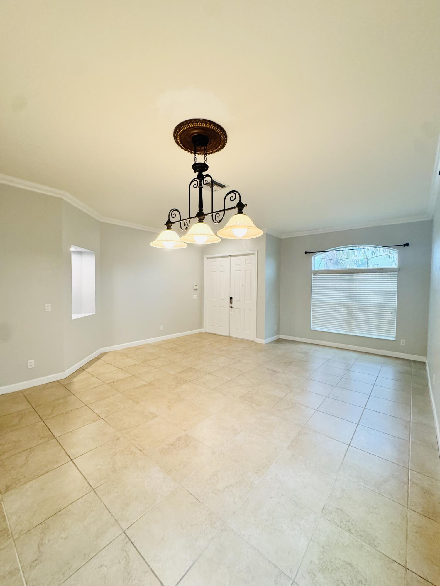 1807 Berkshire Circle Southwest Vero Beach, FL 32968 - Photo 2 of 22 a view of a room with a ceiling fan and window