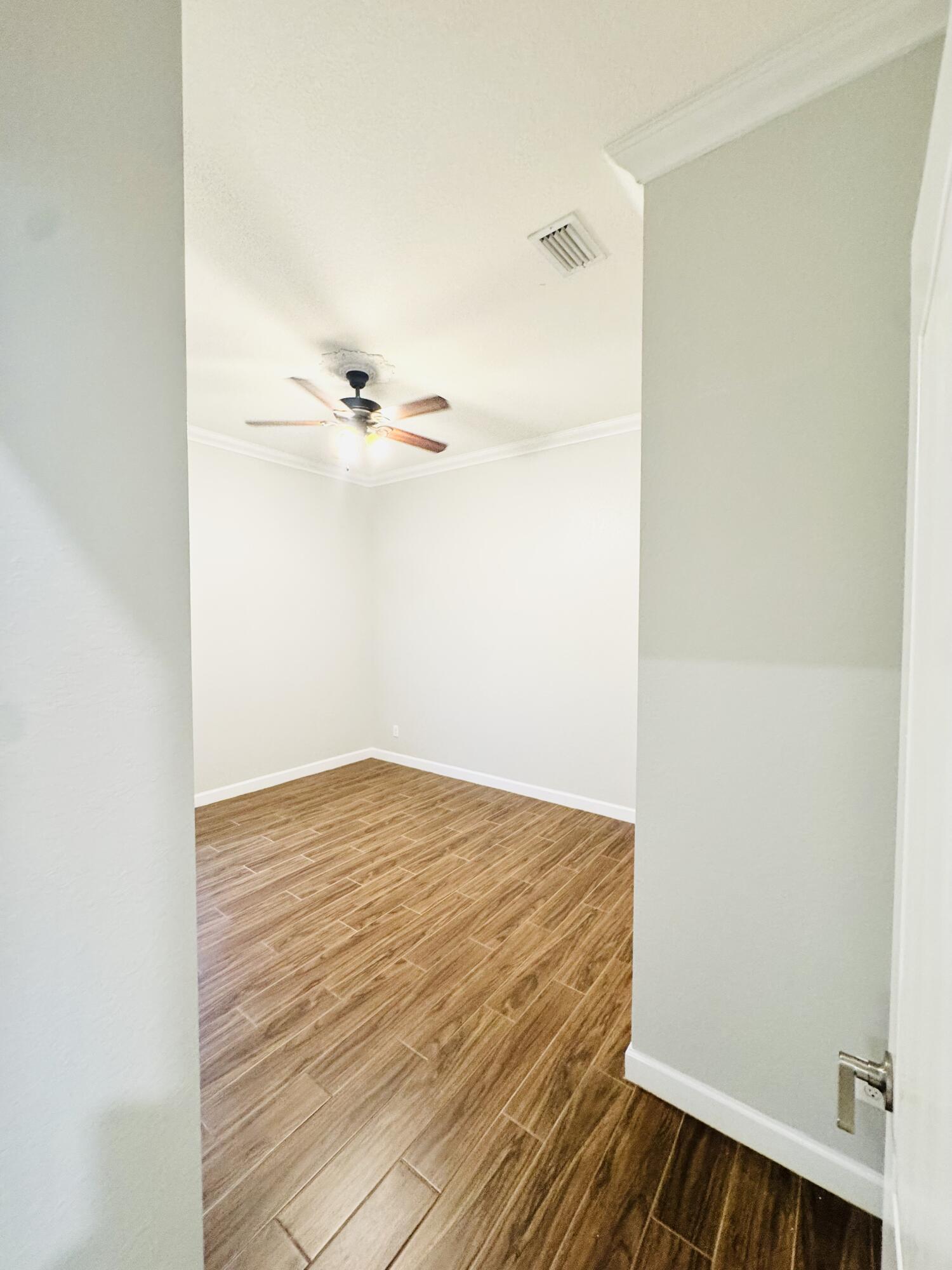 1807 Berkshire Circle Southwest Vero Beach, FL 32968 - Photo 7 of 22 a view of a room with wooden floor
