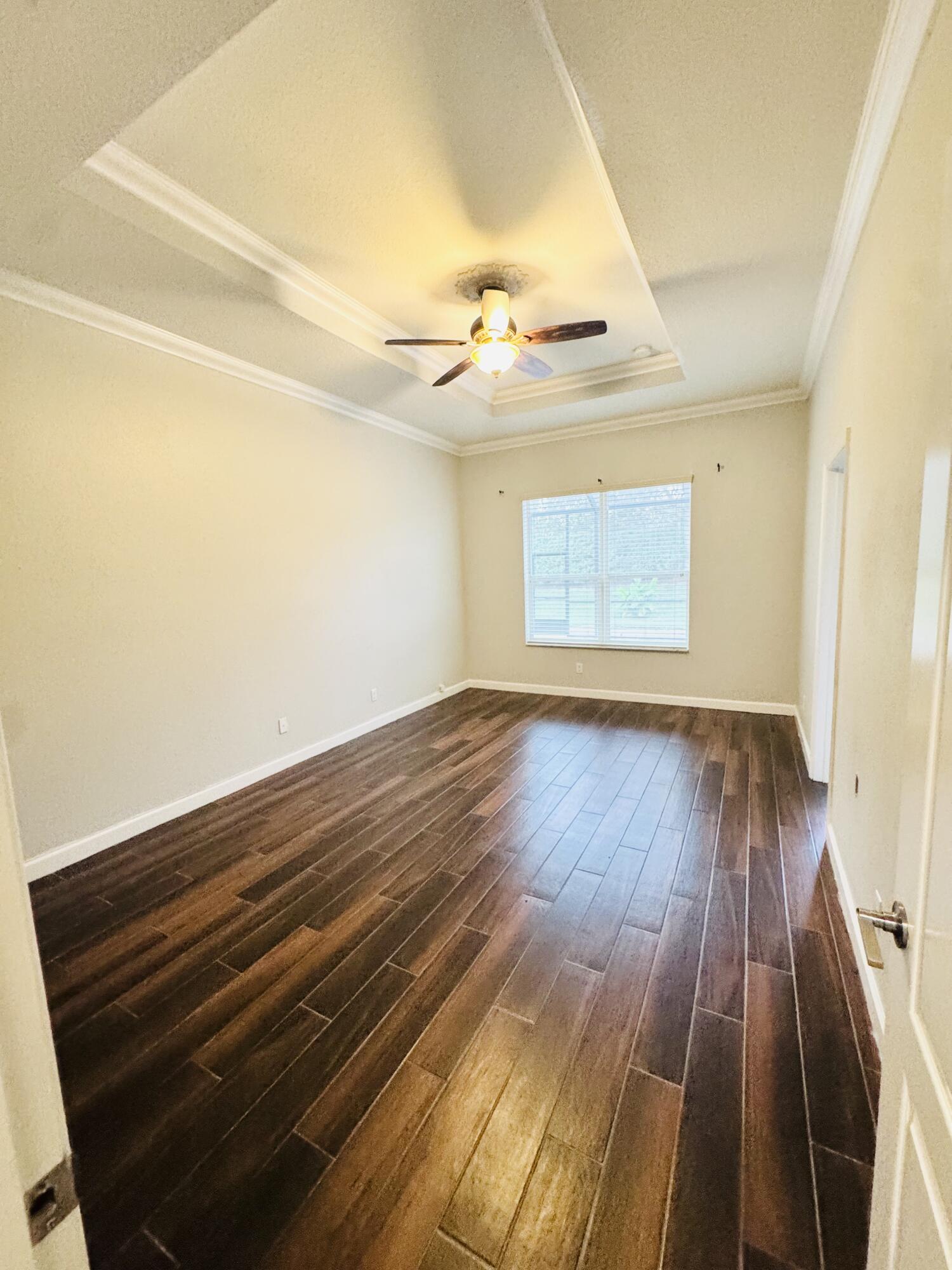 1807 Berkshire Circle Southwest Vero Beach, FL 32968 - Photo 8 of 22 wooden floor in an empty room