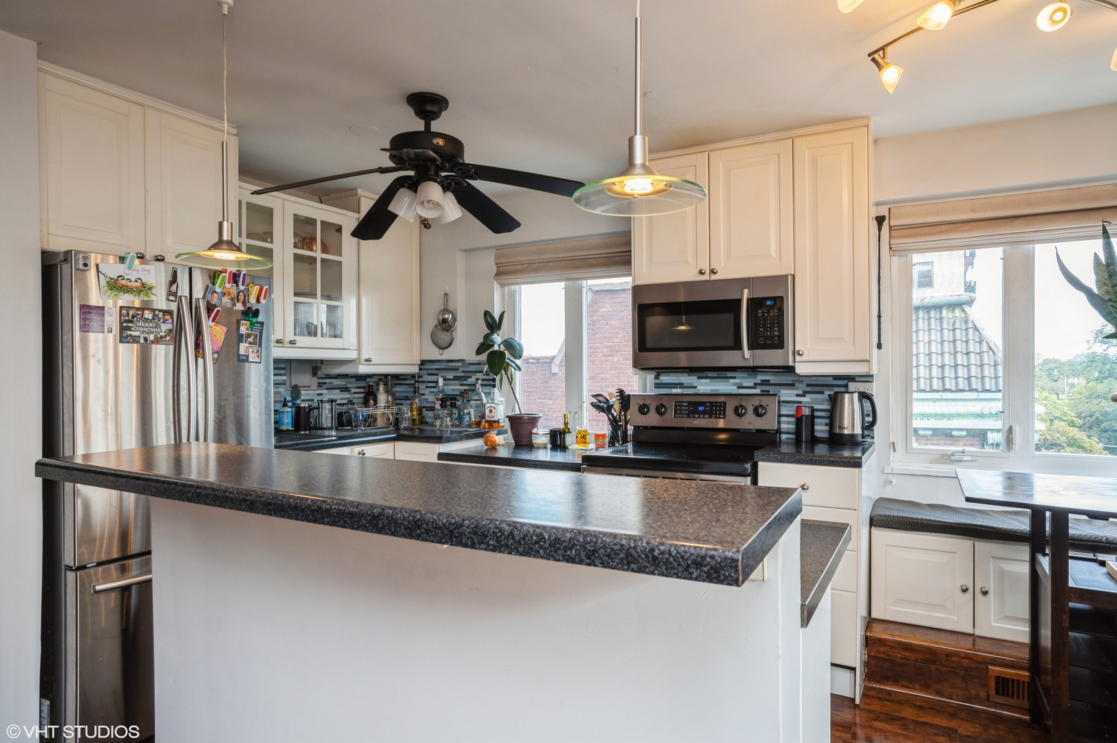 700 West Bittersweet Place, Unit 506 Chicago, IL 60613 - Photo 5 of 11 a kitchen with stainless steel appliances granite countertop a sink a stove and a microwave