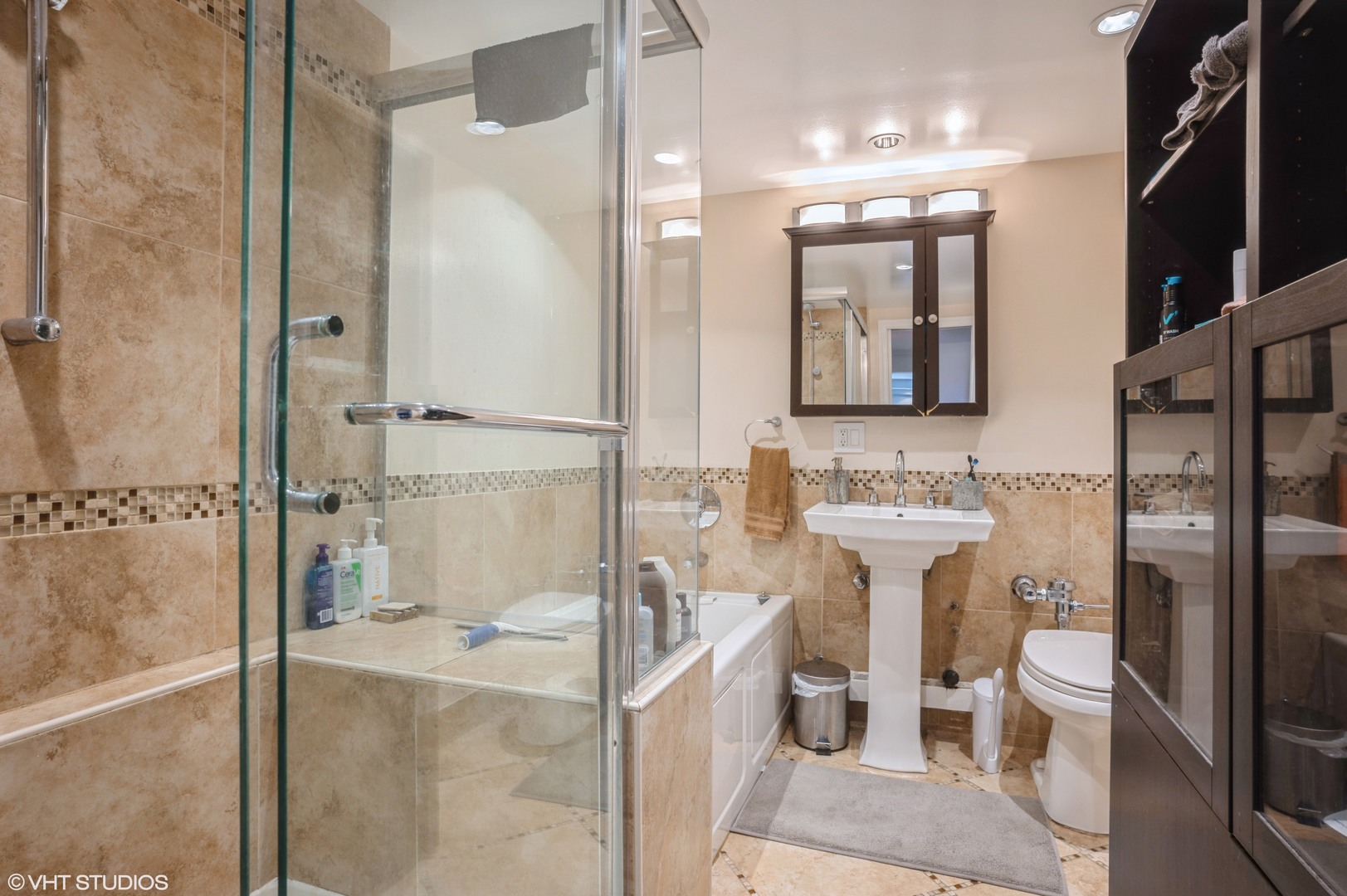 700 West Bittersweet Place, Unit 506 Chicago, IL 60613 - Photo 10 of 11 a bathroom with a bathtub shower sink mirror and toilet