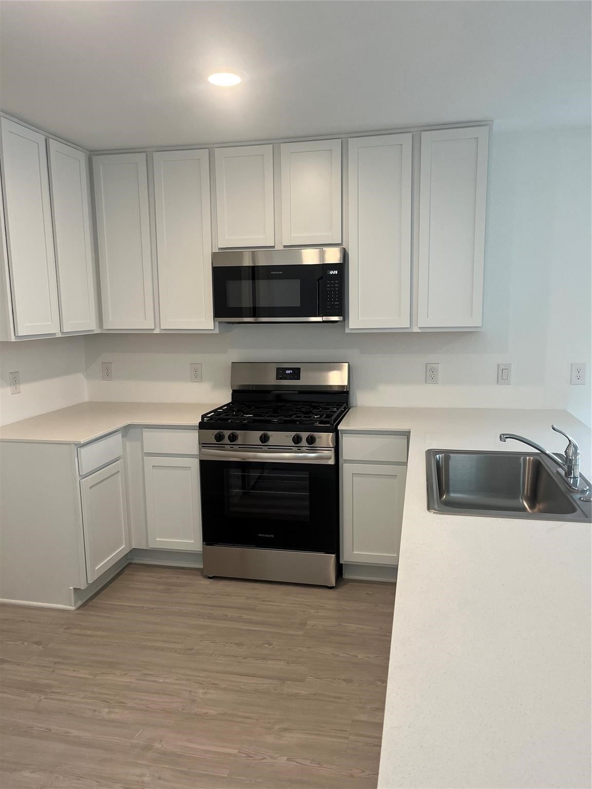 923 Pertuso Lane Huffman, TX 77336 - Photo 4 of 17 a kitchen with granite countertop a sink a stove and cabinets