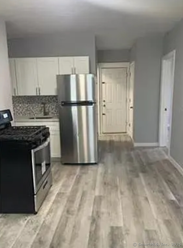 343 Pearl Street Bridgeport, CT 06608 - Photo 1 of 3 a kitchen with a stove a refrigerator and a cabinets