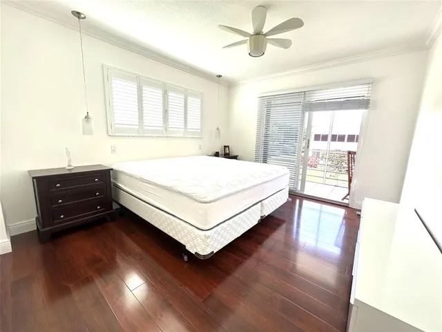 a bed sitting in a spacious bedroom next to a window