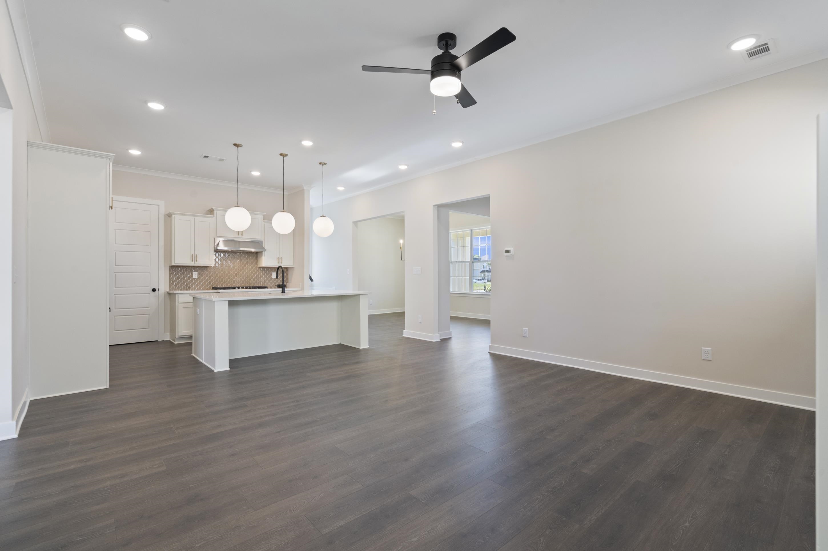 4844 Lyla Lane Collierville, TN 38017 - Photo 11 of 31 Unfurnished living room with dark wood finished floors, recessed lighting, a ceiling fan, and ornamental molding