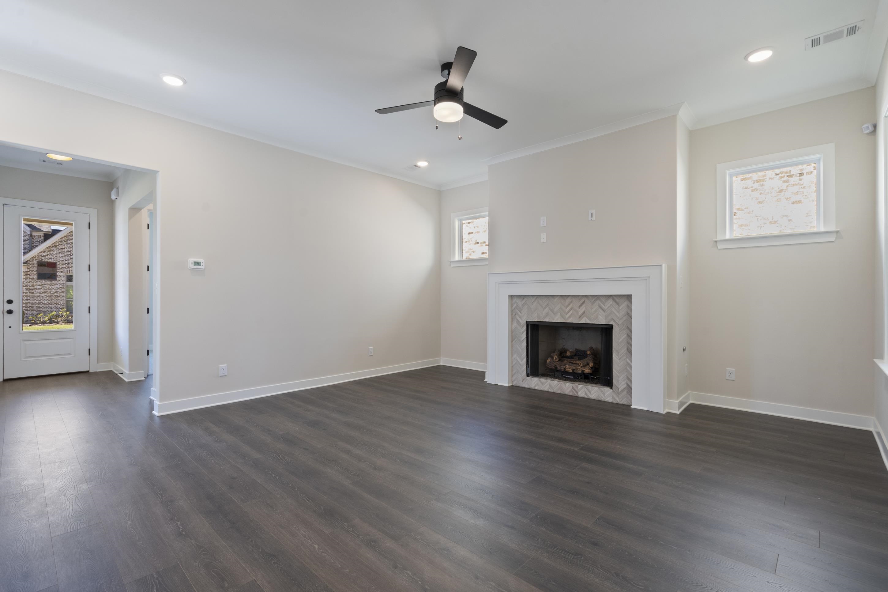 4844 Lyla Lane Collierville, TN 38017 - Photo 13 of 31 a view of an empty room with wooden floor fireplace and a window