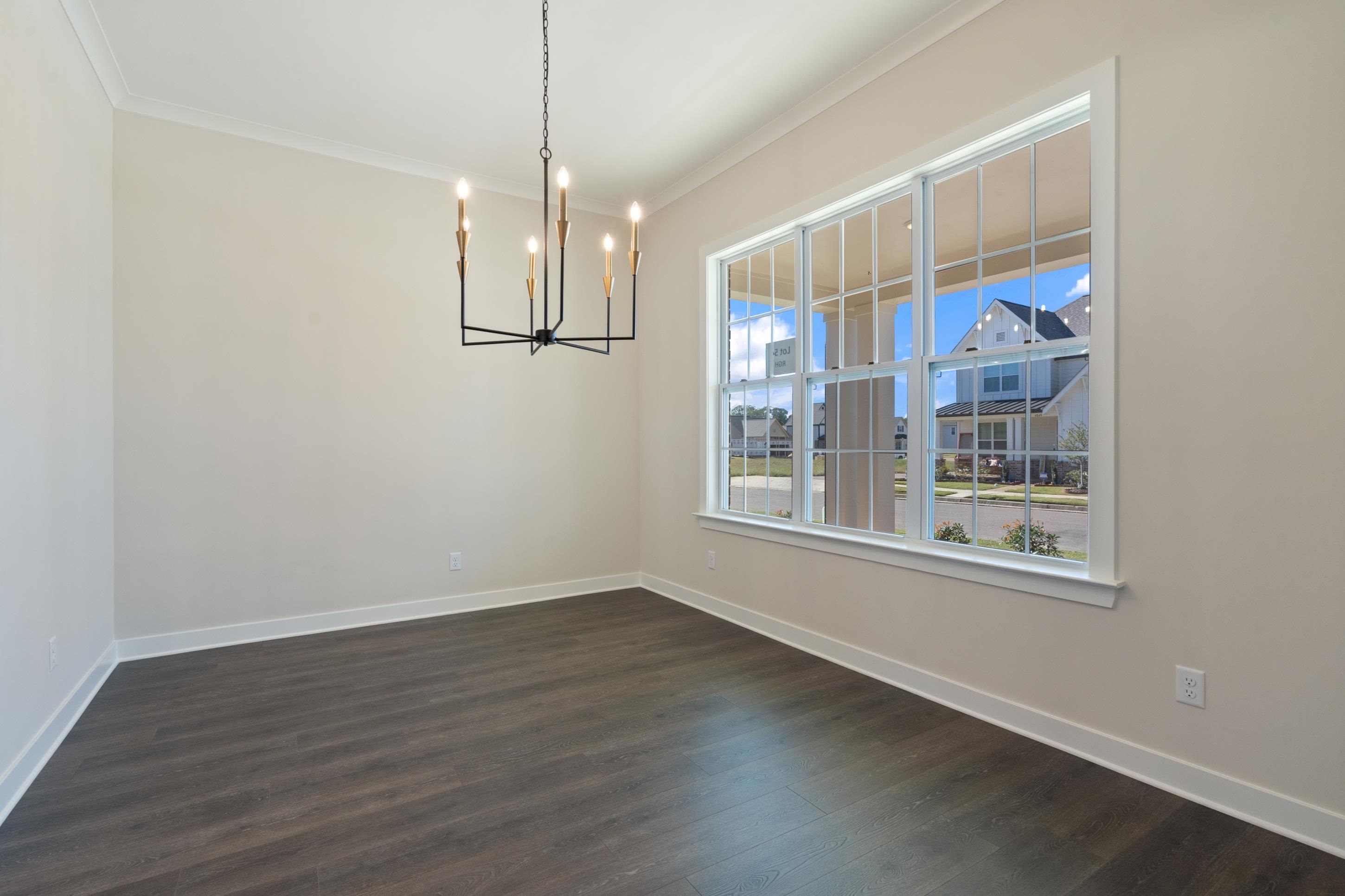 4844 Lyla Lane Collierville, TN 38017 - Photo 7 of 31 a view of an empty room with wooden floor and a window