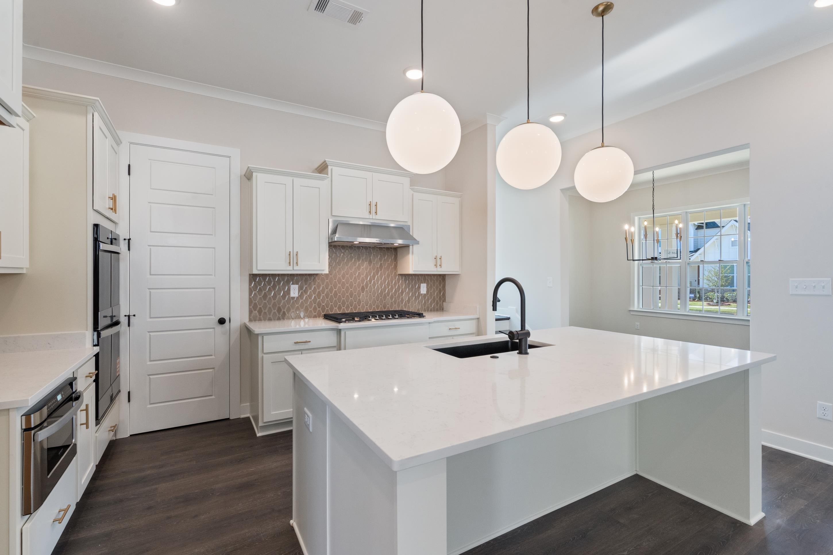 4844 Lyla Lane Collierville, TN 38017 - Photo 8 of 31 a view of a kitchen with a stove and a sink