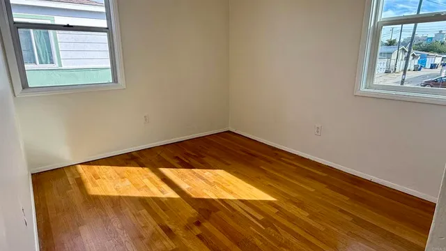 a view of a room with wooden floor and windows