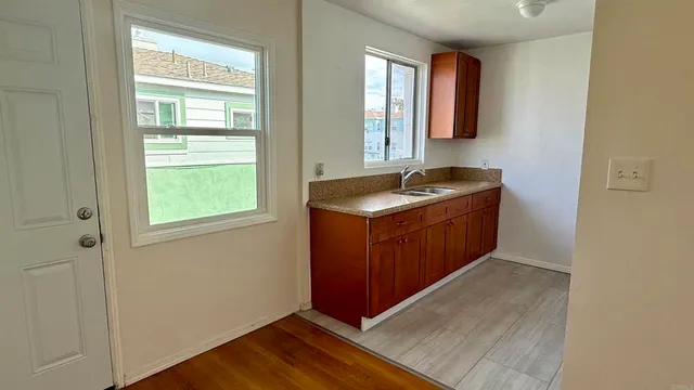 a bathroom with a granite countertop sink a mirror and window
