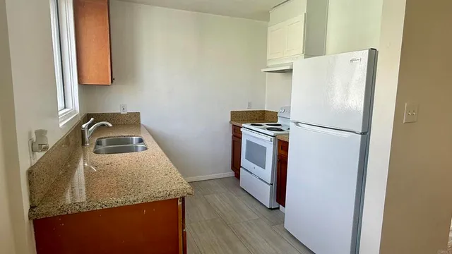 a kitchen with a refrigerator sink and stove