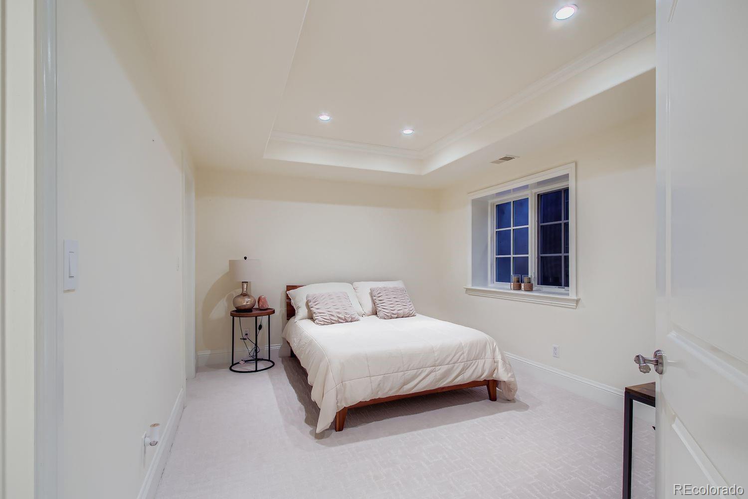 450 Detroit Street Denver, CO 80206 - Photo 25 of 28 a bedroom with a bed and a window