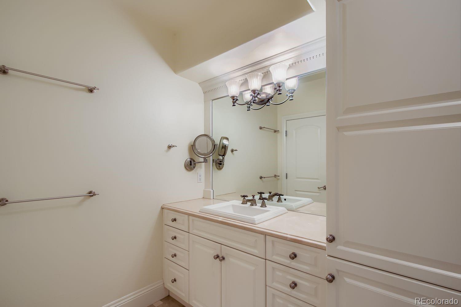450 Detroit Street Denver, CO 80206 - Photo 26 of 28 a bathroom with a sink vanity and a mirror