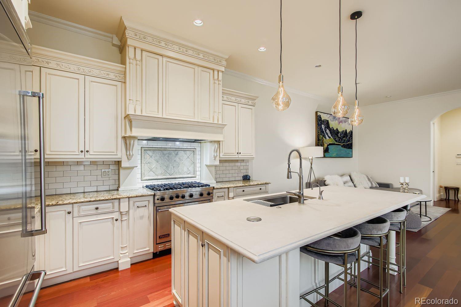 450 Detroit Street Denver, CO 80206 - Photo 6 of 28 a kitchen with a sink a stove and white cabinets