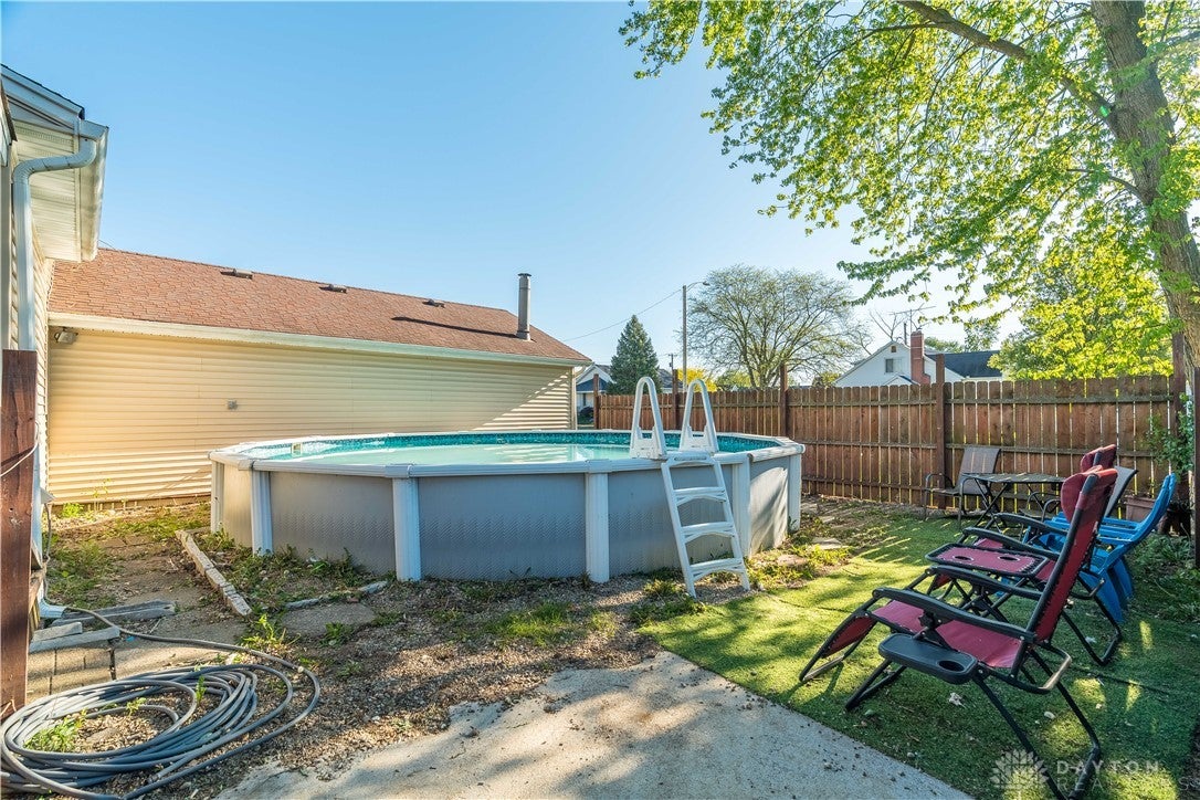 220 Racer Street Troy, OH 45373 - Photo 31 of 33 This backyard features an above-ground pool, surrounded by privacy fence, creating a private outdoor oasis.