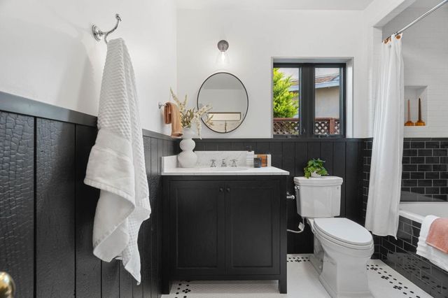 a living room with a table chairs and a wooden floor
