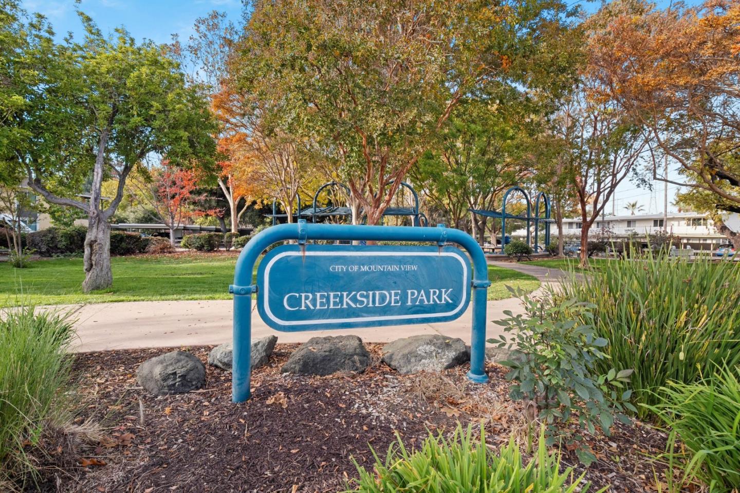 58 Gladys Avenue Mountain View, CA 94043 - Photo 40 of 42 a sign board with a bench and trees