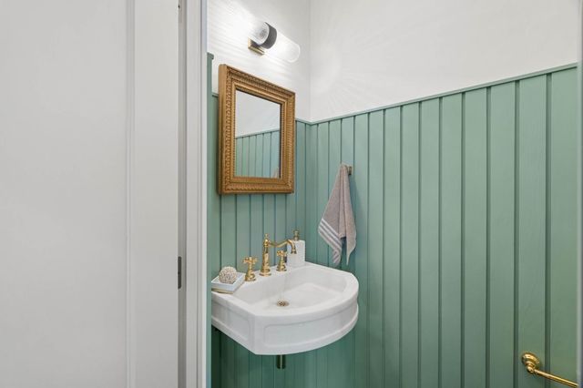 a bathroom with a sink a mirror and a window